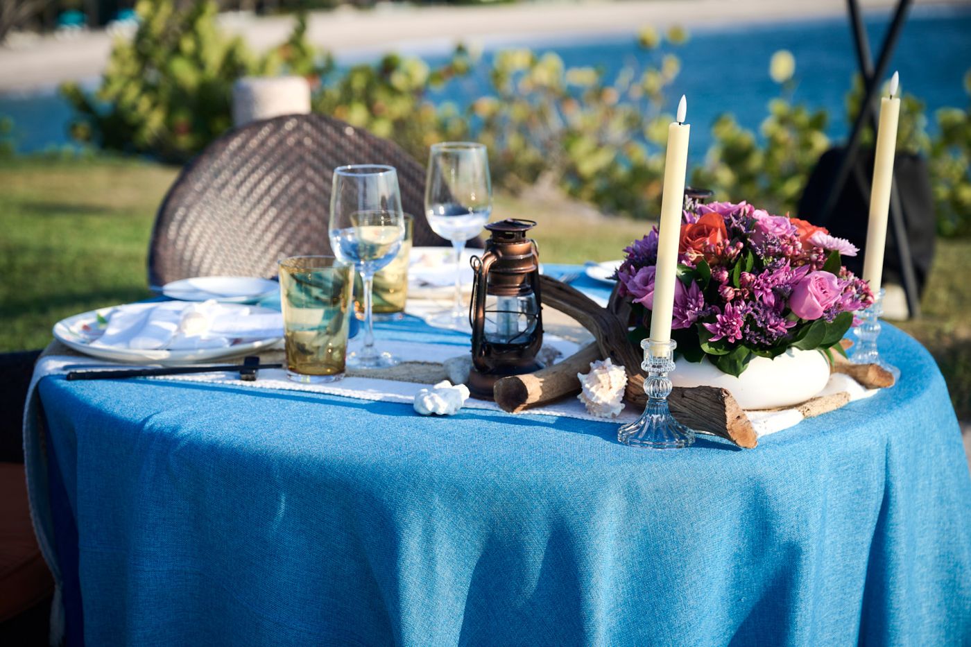 Oceanside table with candles and flowers