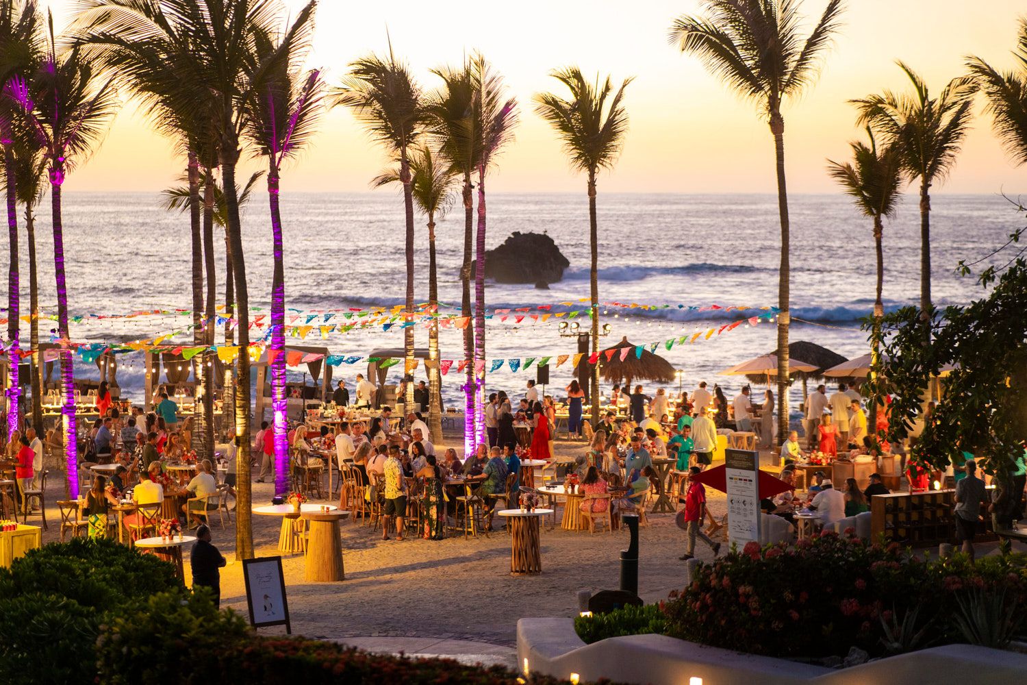 Beachfront gala at sunset under palm trees